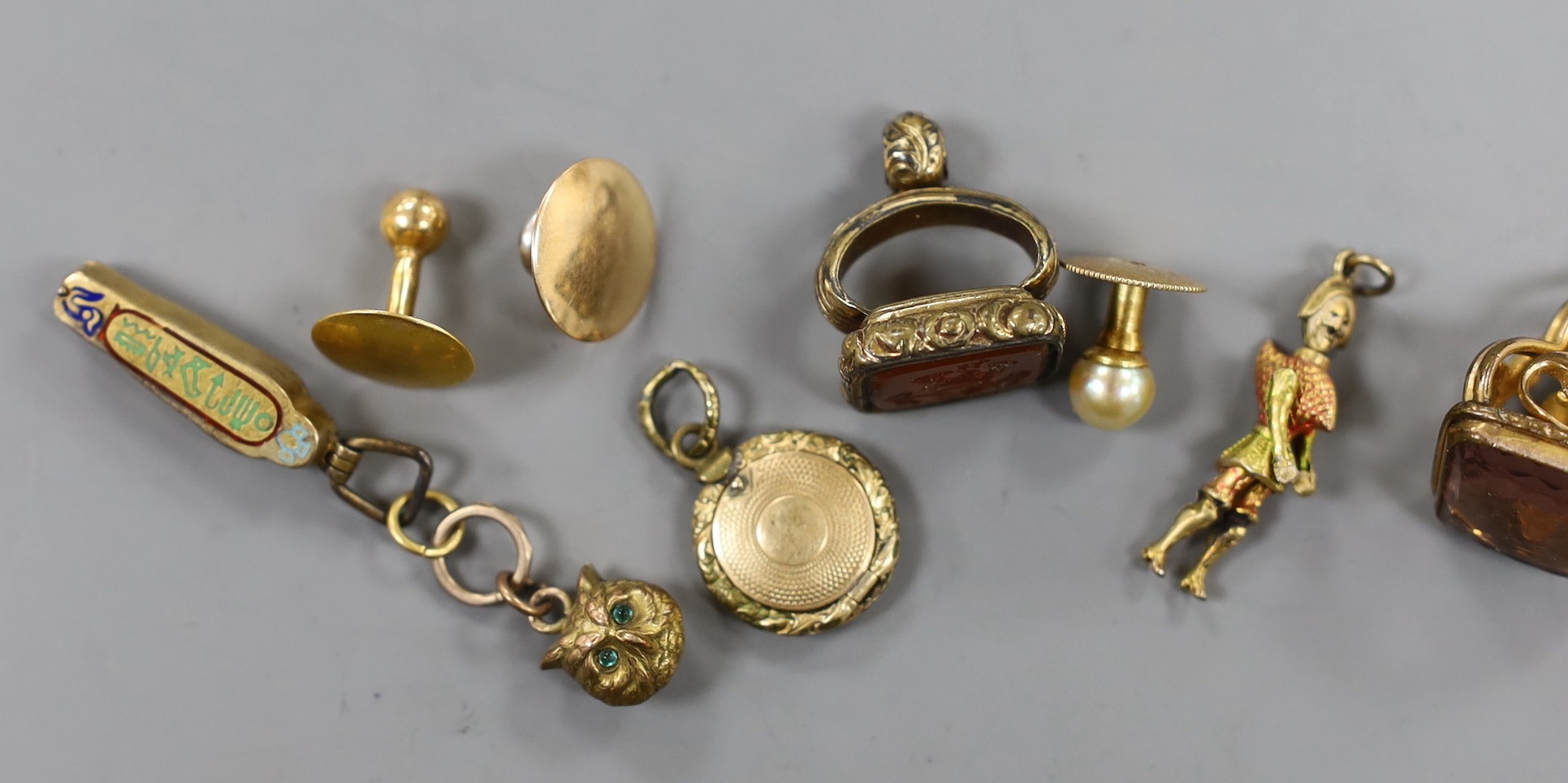 Mixed small jewellery including three yellow metal dress studs, an Egyptian 'mummy' charm, two 19th century gilt metal and semi-precious gem set fob seals and two other items including a gilt metal locket.